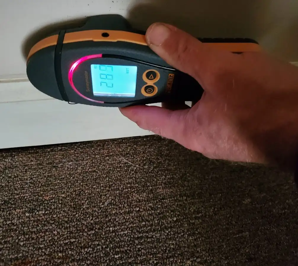 Moisture detection at baseboard during Storm Damage Restoration in Swannanoa